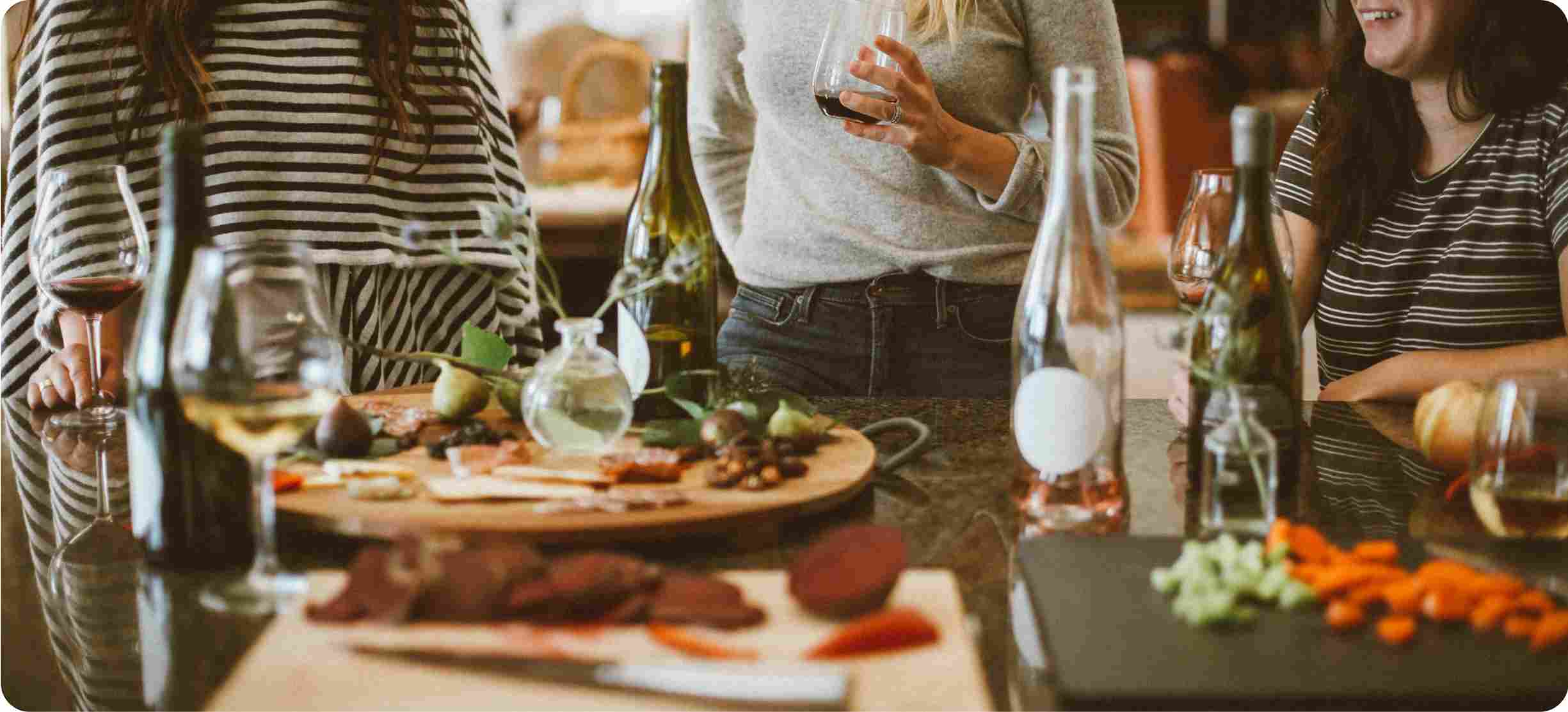 People gathered around a table with food and drinks